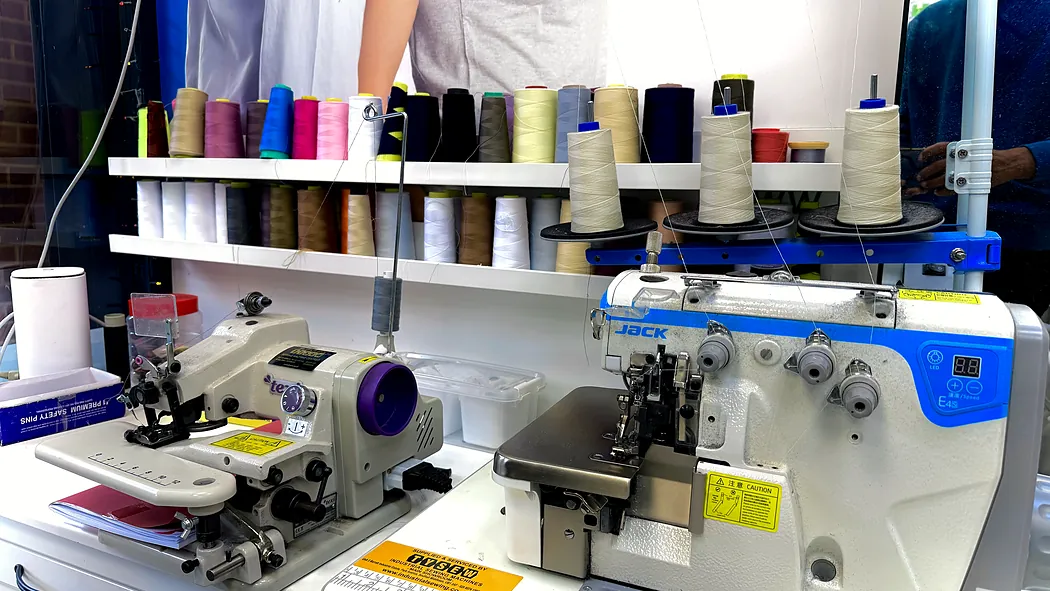 The thread rack above our overlockers, colours matched to each garment